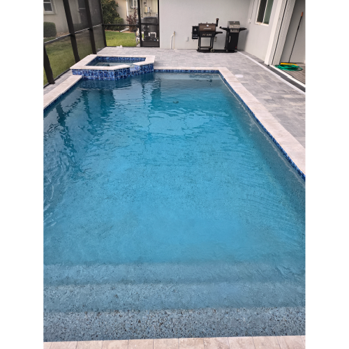 Custom residential pool and spa with automation-ready heating system and gray paver deck in Burnt Store Meadows, Florida.