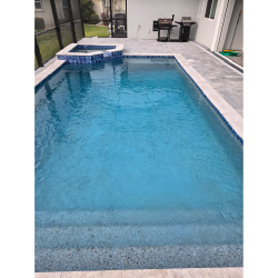 Custom residential pool and spa with automation-ready heating system and gray paver deck in Burnt Store Meadows, Florida.