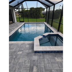 Custom shotcrete pool with attached spa and gray travertine decking built by H2Oasis Pools & Spas in Burnt Store Meadows, Florida.