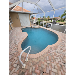 Lagoon-style pool with PebbleTec finish and saltwater system built by H2Oasis Pools & Spas in Punta Gorda, Florida.